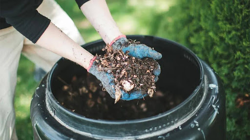 someone-holding-compost-over-bin