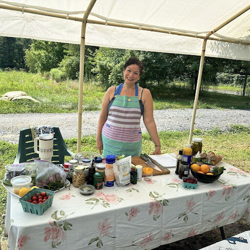 woman-smiling-at-table-with-food
